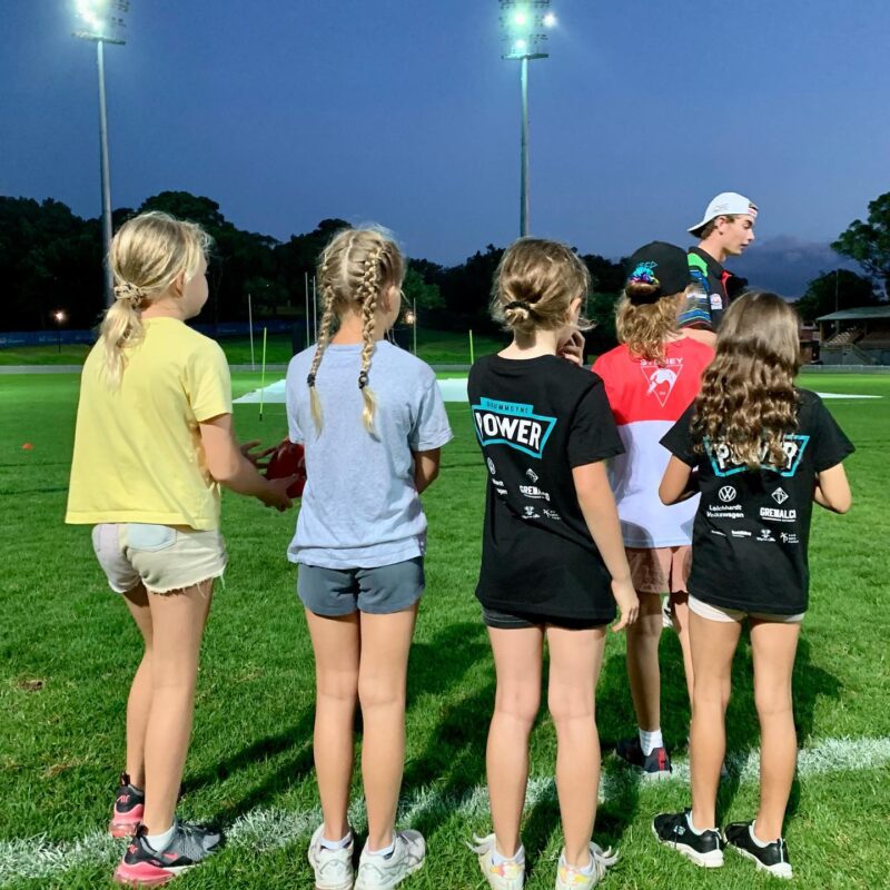 Young footy players getting some tips from their coaches 